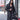 Black Runic Cardigan worn with the hood up, showing the tonal print and draped open front.