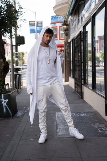 White Runic Cardigan worn with the hood up, showing the long open-front silhouette.