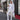 White Runic Cardigan shown from an angle with the hood up and long draped front panels.