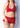 Woman wearing a red halter top and skirt with a plain background