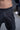 Runic Cargo Pants in black, close-up of tonal Runic print, waistband and front pocket