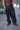 Unisex Combat runic Pants in black with tonal Runic print and buckle straps, front view